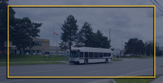 A Burlington Transit bus stopped in front of the transit headquarters